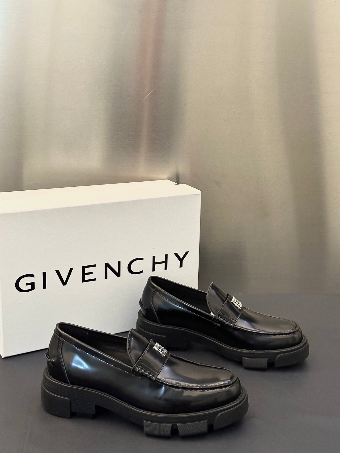 Black leather loafers, rounded toe and logo buckle strap