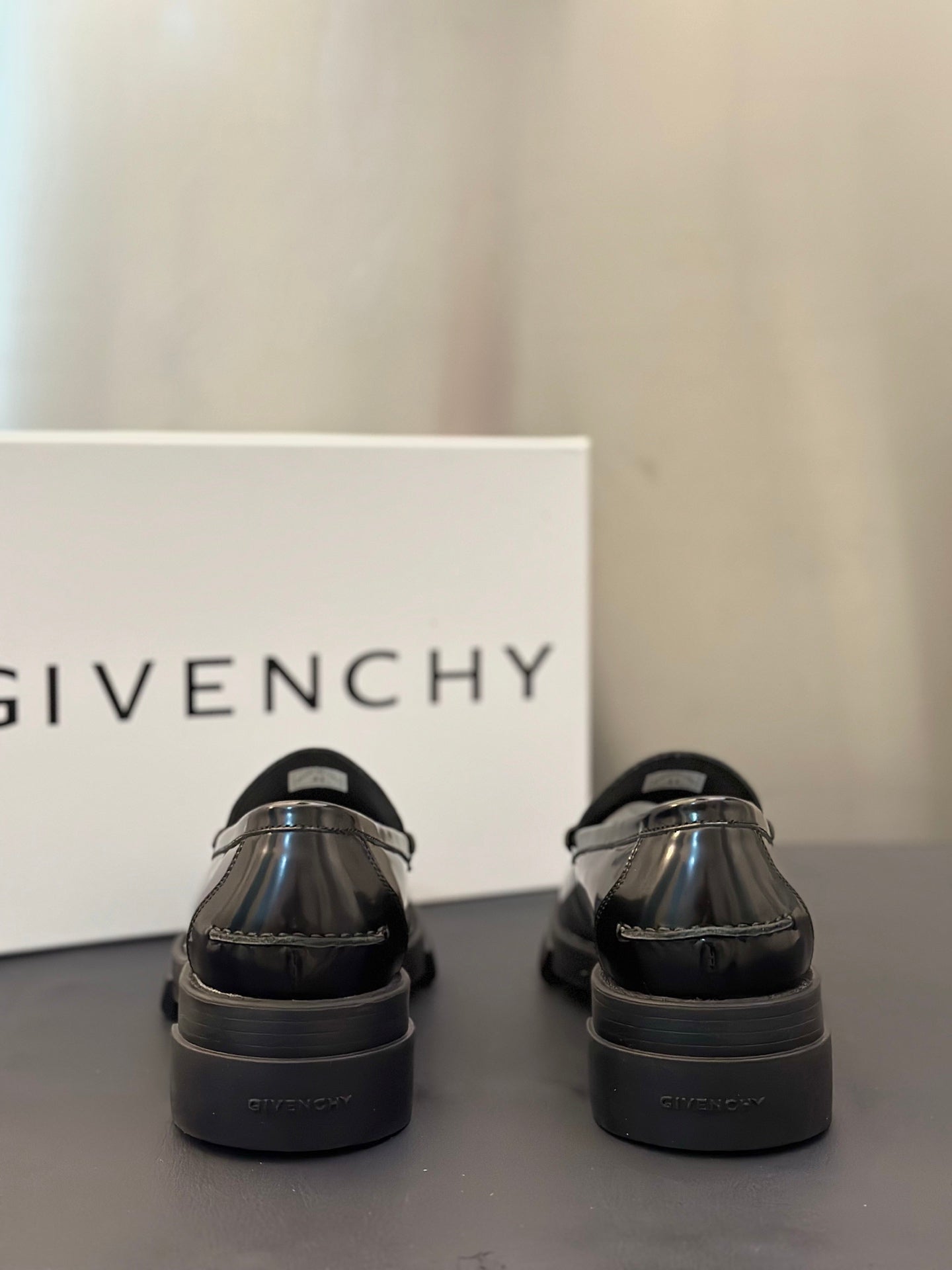 Black leather loafers with heel tab and rear seam detail