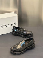 Black leather loafers with silver logo buckle, low block sole