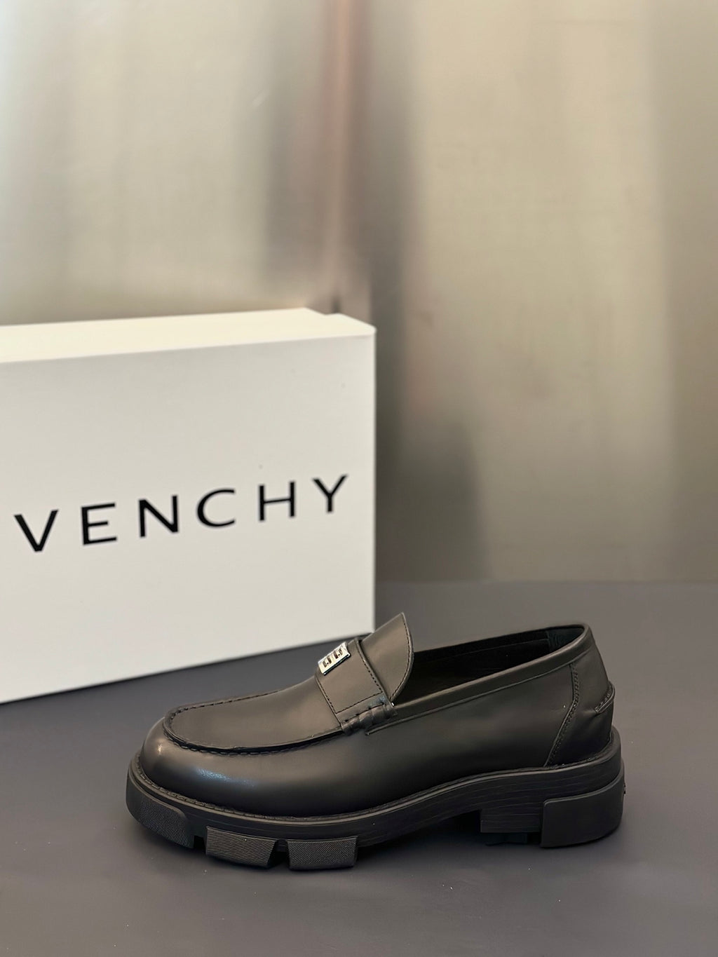 Single dark leather loafer with square logo buckle strap and chunky platform sole