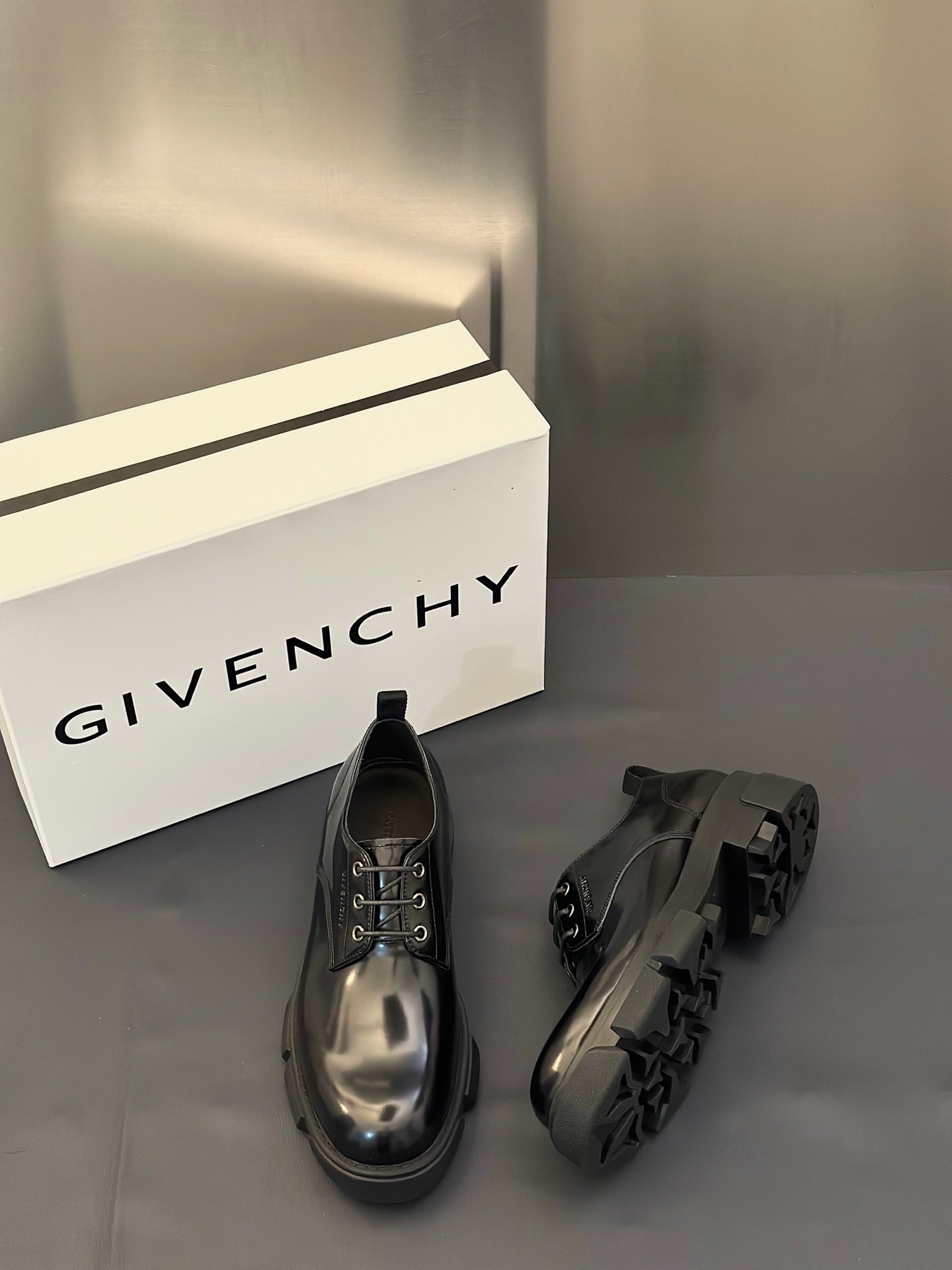 Black leather lace-up derby shoe and black leather shoe with chunky buckle strap