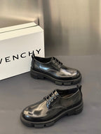 Black leather lace-up derby shoes with eyelets and chunky tread sole