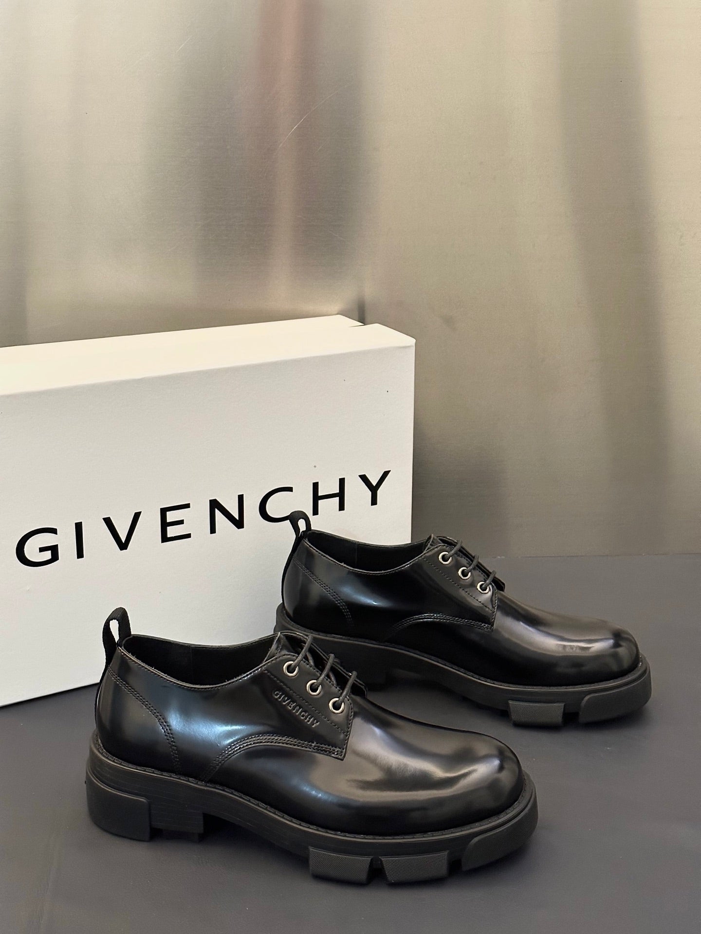 Black leather lace-up derby shoes with chunky sole and stitched toe cap