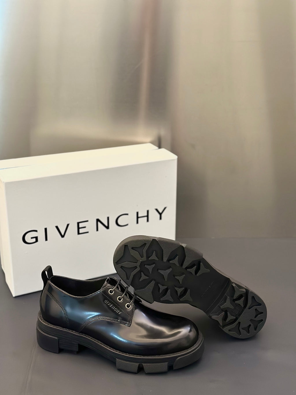 Black rubber outsole with deep tread pattern for lace-up derby shoes