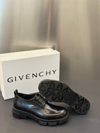 Black rubber outsole with deep tread pattern for lace-up derby shoes