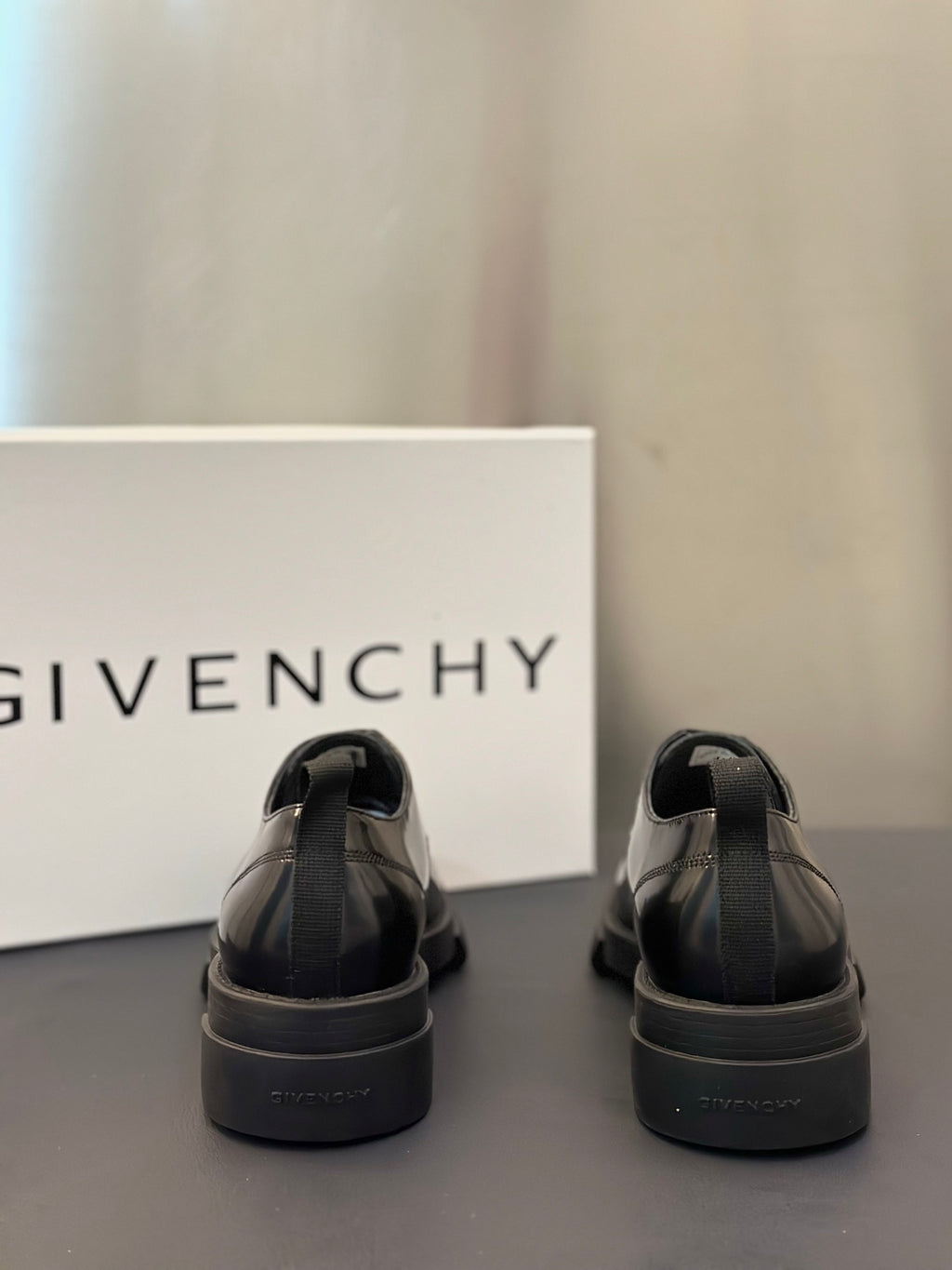 Black leather derby shoes with rear heel tab and chunky rubber sole