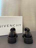 Black leather derby shoes with rear heel tab and chunky rubber sole