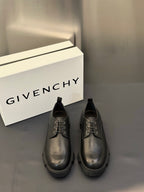 Black leather lace-up shoes with metal eyelets and thick tread sole