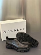 Black leather lace-up shoes with star-textured rubber outsole and chunky sole