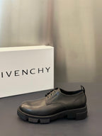 Dark leather lace-up shoe with thick sole, side view.