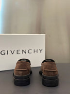 Brown suede loafers, rear view, with dark rubber sole and low heel