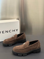 Brown suede loafers with logo plaque strap and dark treaded sole, pair view