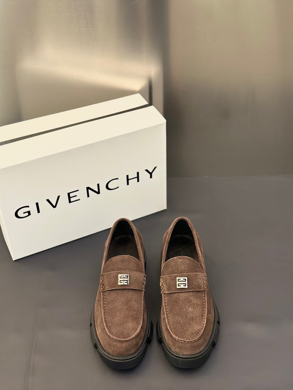 Brown suede loafers with logo plaque strap and thick dark rubber sole