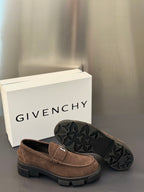 Brown suede loafers with logo plaque strap; outsole with textured tread shown