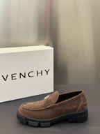 Brown suede loafer with logo plaque strap and thick dark rubber sole