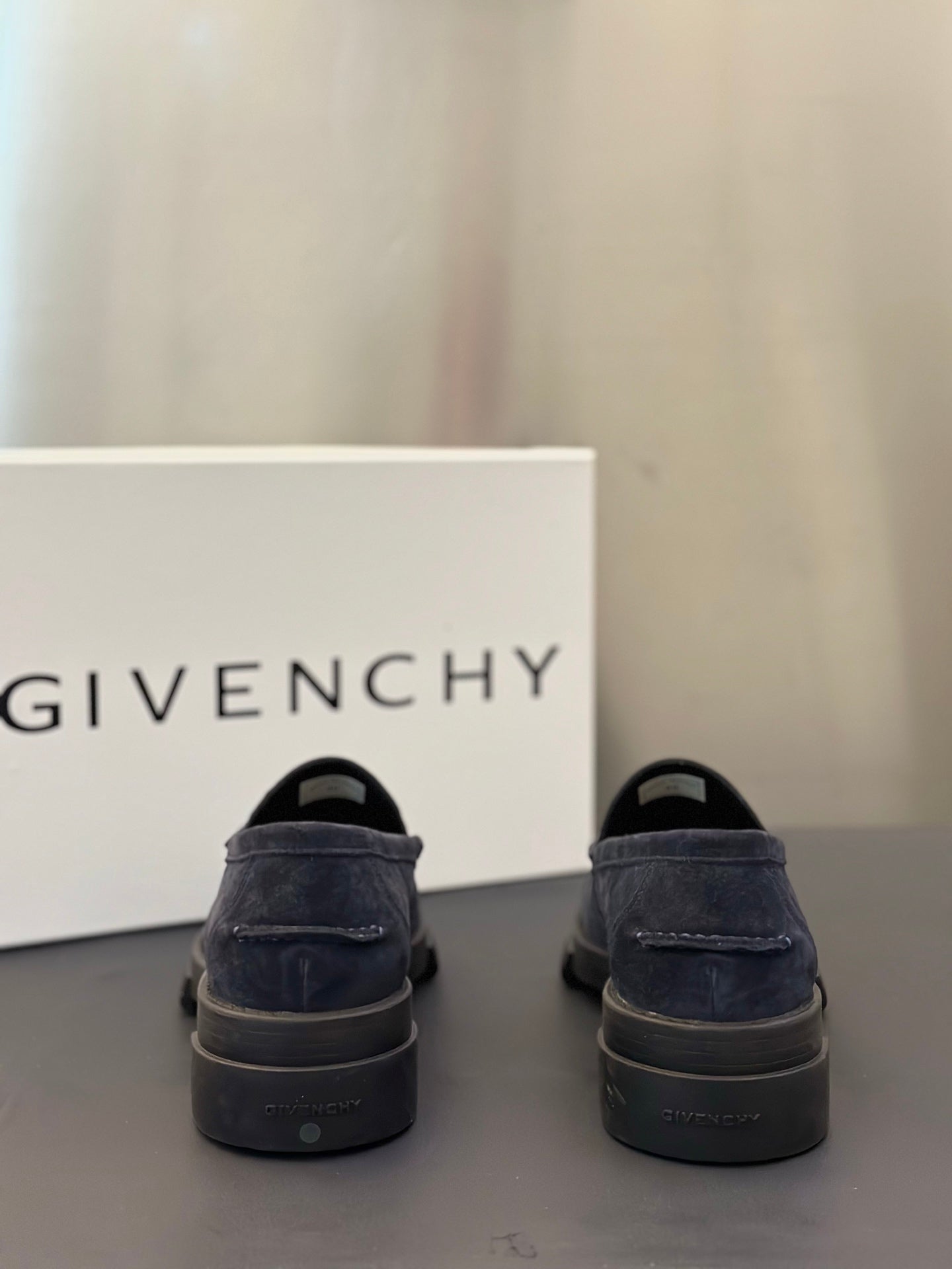 Givenchy suede loafers, dark navy, back view with heel tread and logo detail