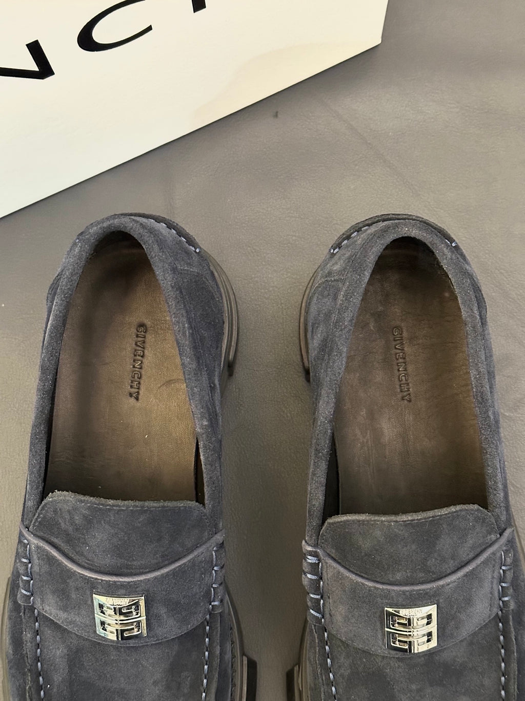 Givenchy suede loafers, dark suede, close-up of metal logo on vamp