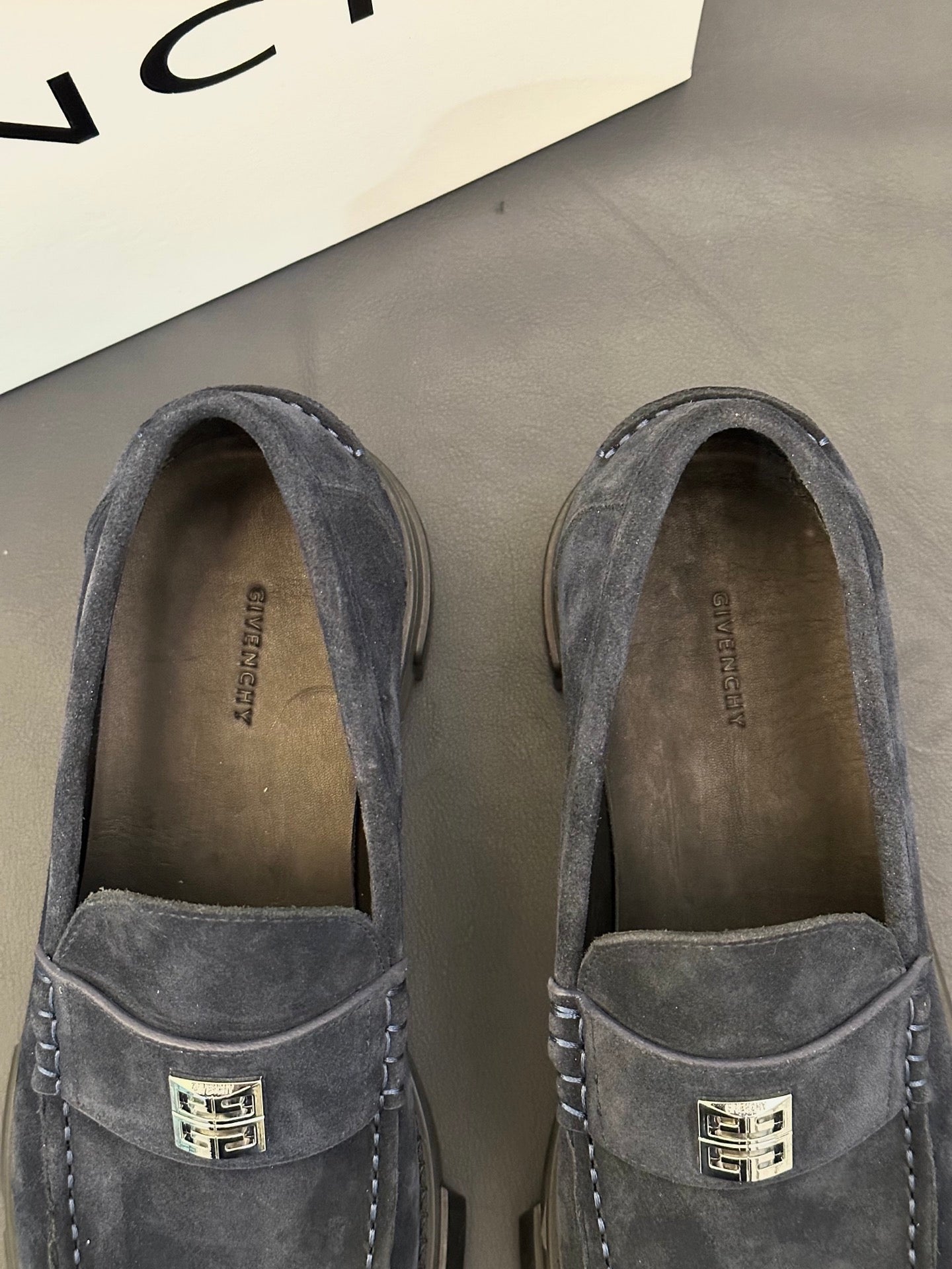 Givenchy suede loafers, dark suede, close-up of metal logo on vamp