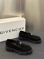 Black slip-on loafers with front strap detail and chunky lug sole, side angle