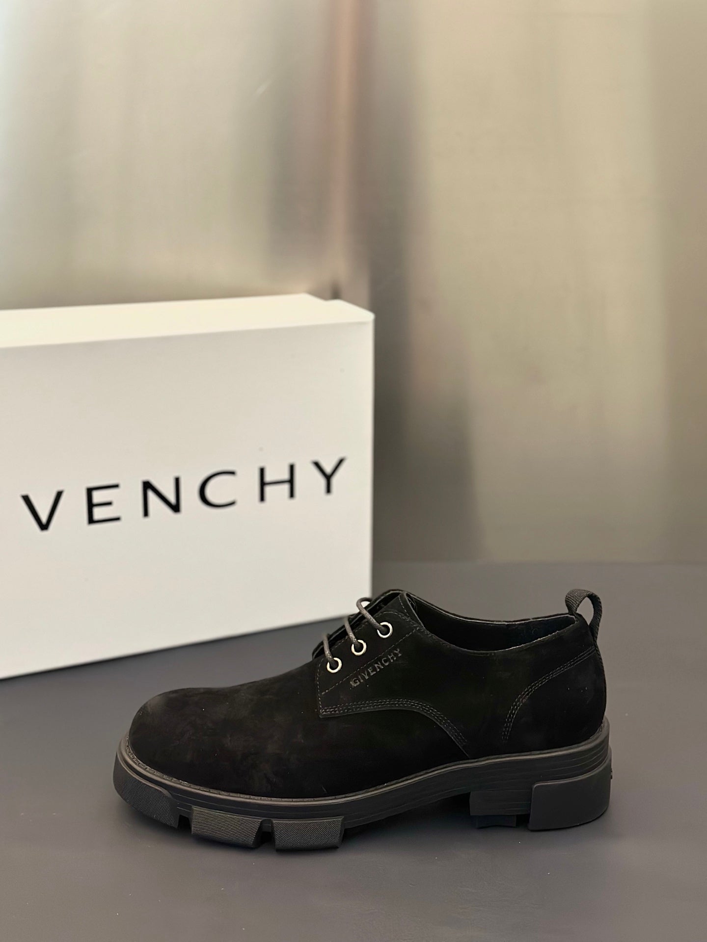 Black lace-up oxford shoes with metal eyelets and grippy rubber outsole.