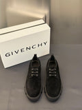 Black lace-up shoes with metal eyelets and chunky rubber sole.