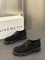 Black lace-up oxford shoes with round toe and chunky rubber outsole.