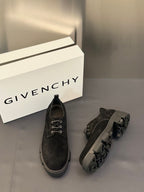 Black lace-up shoes with low heel, metal eyelets, and side profile detailing.