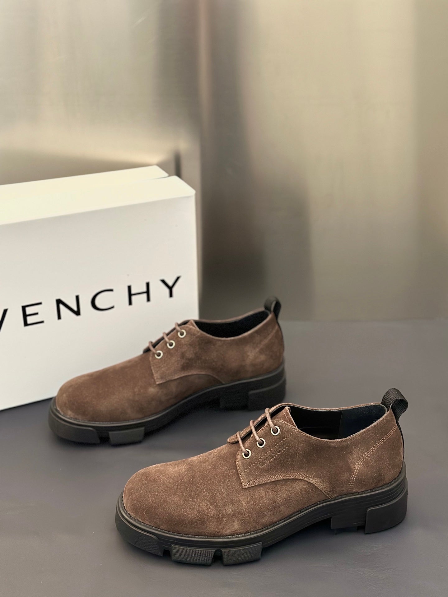 Brown suede lace-up oxford shoes with low heel and chunky dark rubber sole