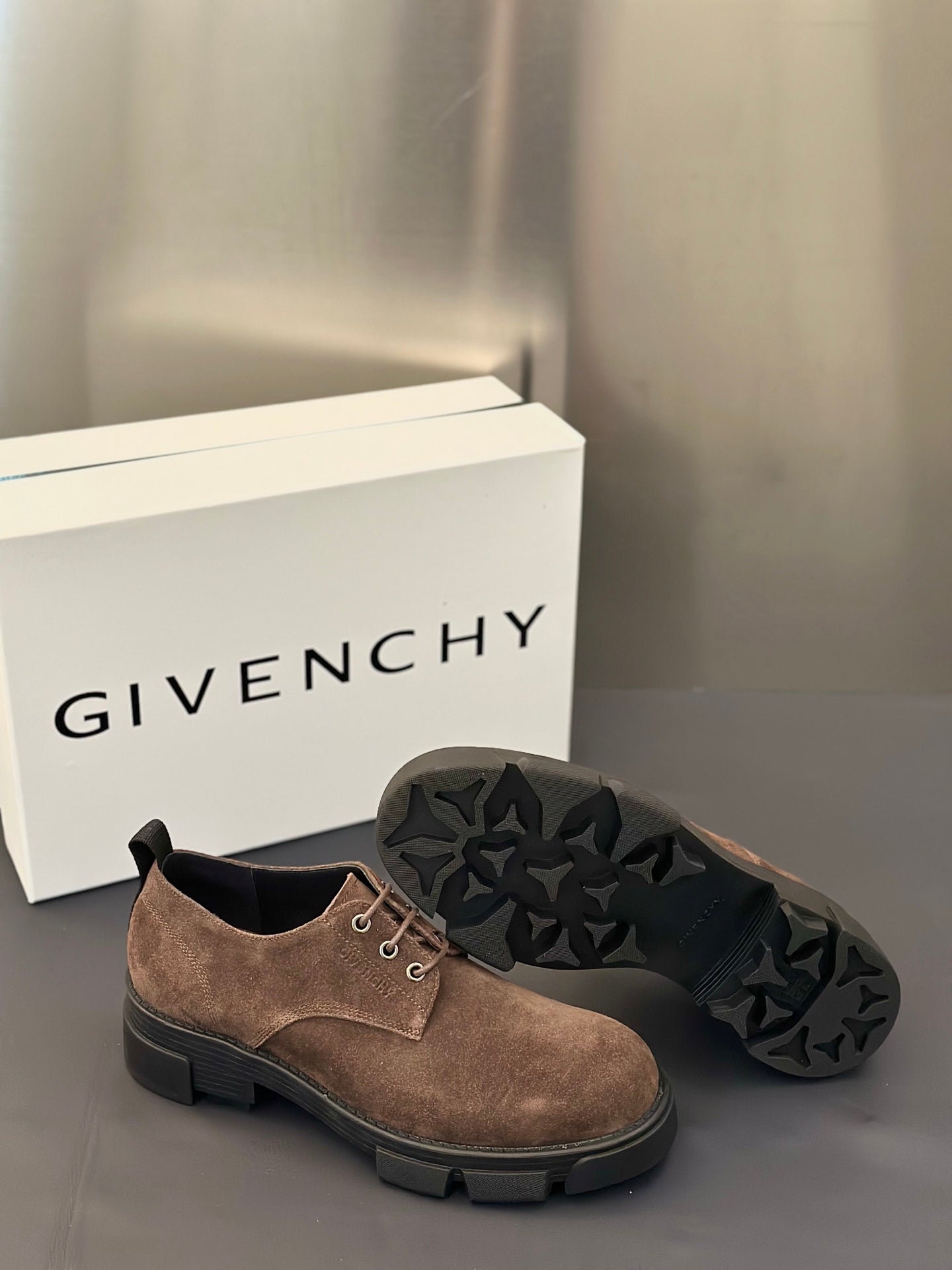 Brown suede lace-up shoes with textured tread outsole and chunky dark rubber sole