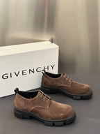 Brown suede lace-up shoes with thin metal eyelets and chunky dark rubber sole