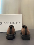 Brown suede lace-up shoes from the heel view with chunky dark rubber soles