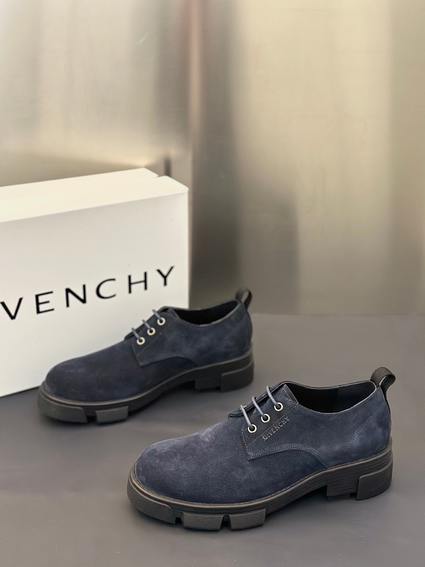 Navy suede lace-up shoes with low profile heel and rubber tread sole
