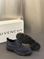Navy suede lace-up shoes with visible treaded outsole and lace-up front