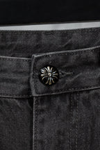 Dark denim pants with round metal button at the waistband
