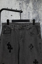 Dark denim pants with cross embroidery on front and button waistband