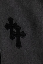 Black cross appliqué on dark gray denim pant leg