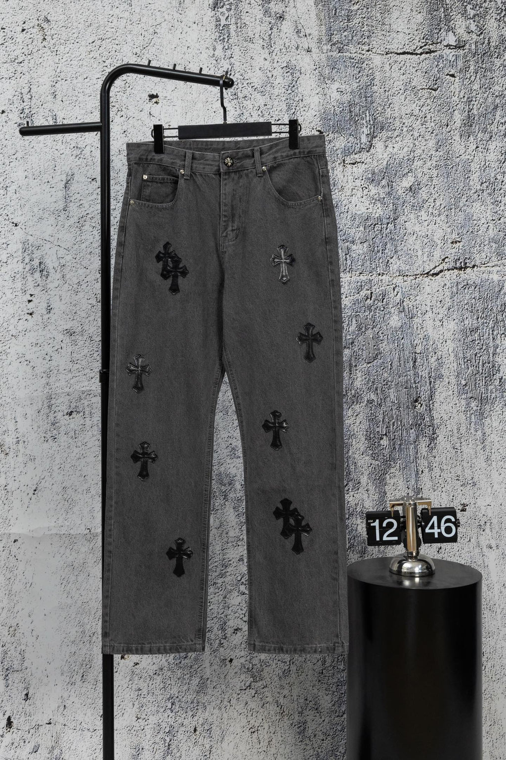 Dark gray denim pants with black cross appliques, straight leg, button and zip fly