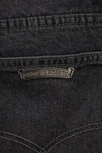 Dark denim pants with embroidered logo patch on front pocket