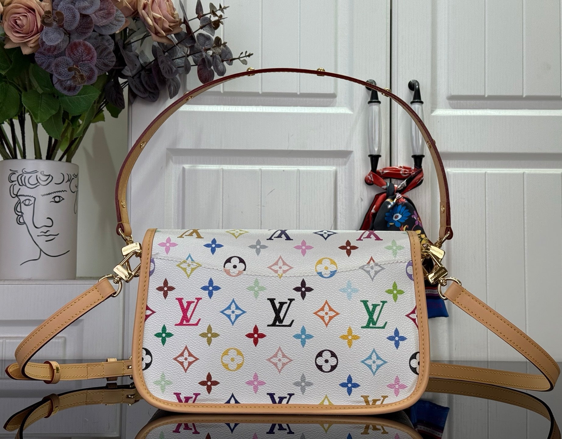 Louis Vuitton handbag with multicolor monogram canvas, top flap and tan leather handles