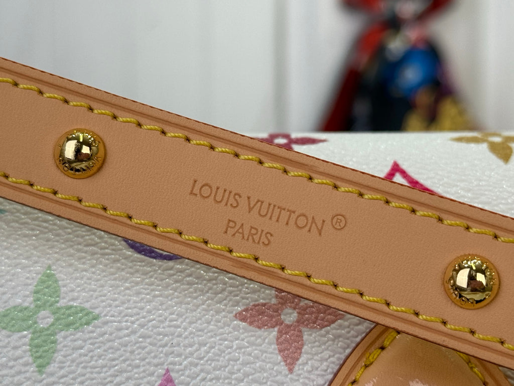 Louis Vuitton strap with “Louis Vuitton Paris” text and gold-tone studs on tan leather