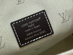 Canvas label stitched to cream fabric reading Louis Vuitton Paris and made in Spain