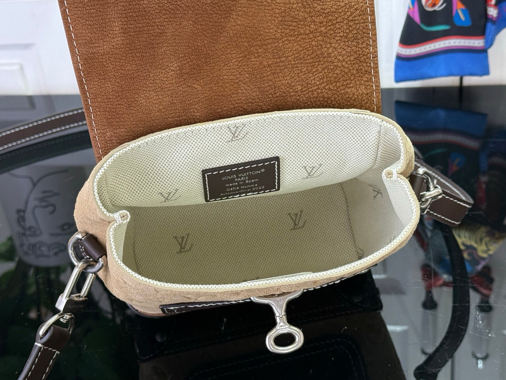 Mini backpack interior pocket with beige lining and repeating monogram pattern