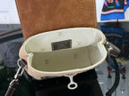 Mini backpack interior pocket with beige lining and repeating monogram pattern