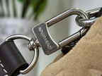 Metal clasp with engraved Louis Vuitton text on brown leather mini backpack strap