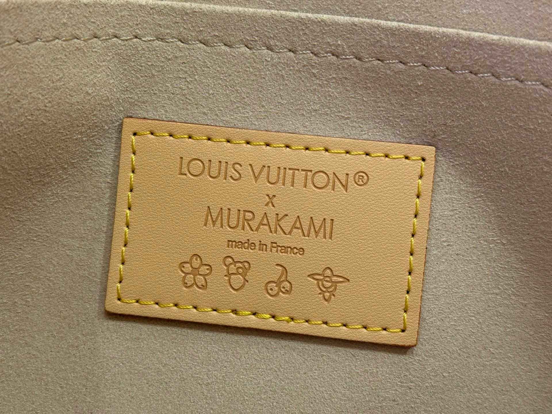 Louis Vuitton Murakami edition bag label, stitched tan leather tag with printed text