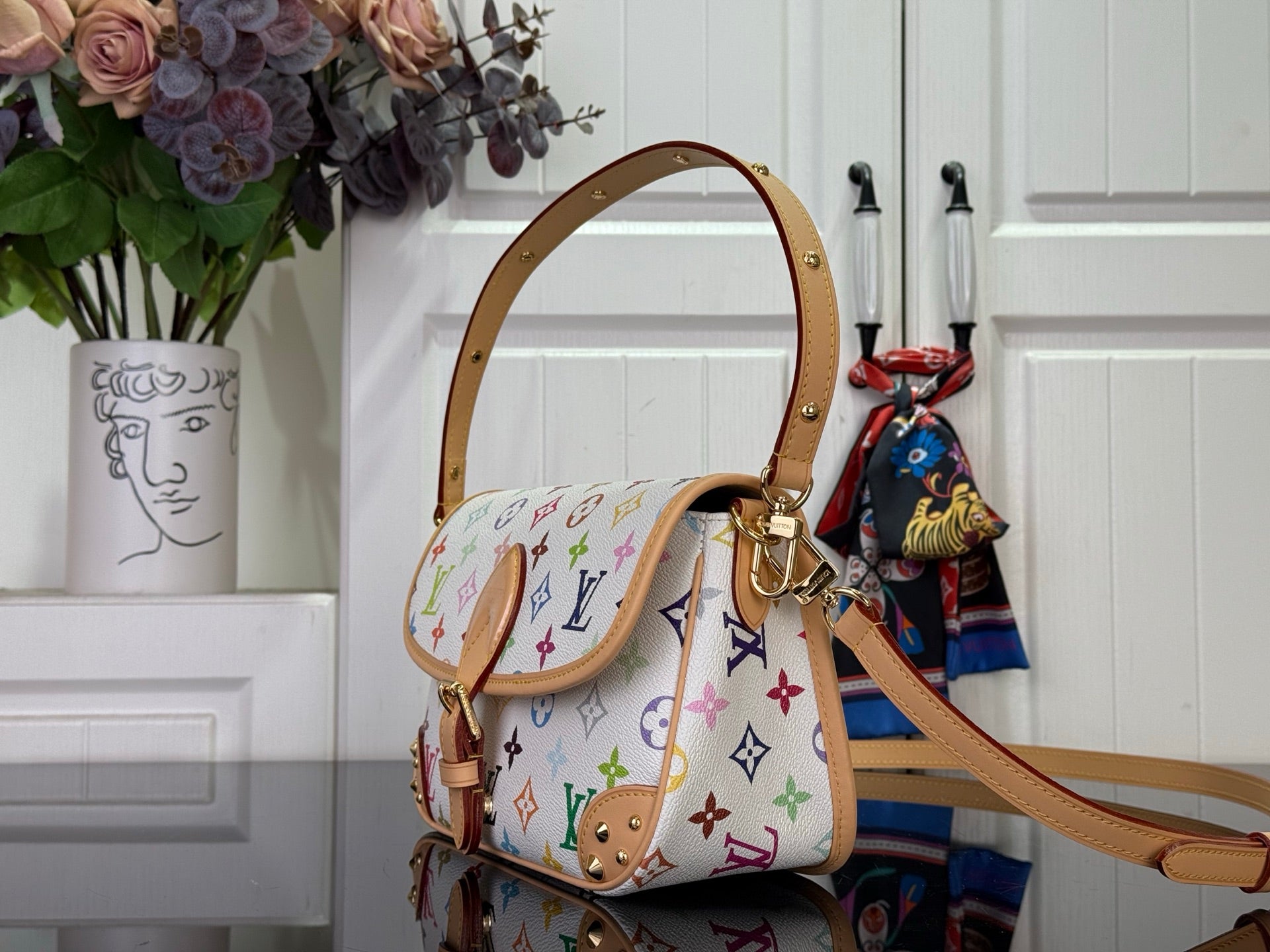 Louis Vuitton crossbody bag, multicolor monogram canvas, tan leather strap and buckle