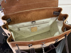 Handbag interior with tan monogram lining, zip pocket, hanging clasp and strap hooks