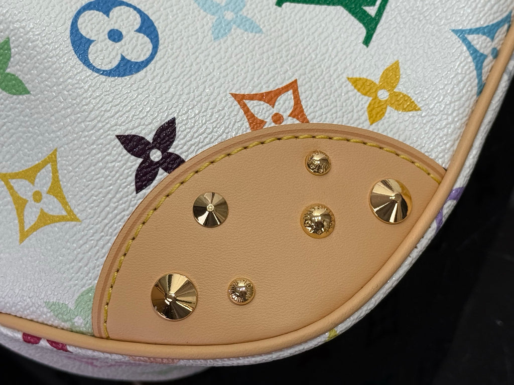 Louis Vuitton monogram bag corner detail with tan patch and gold rivets