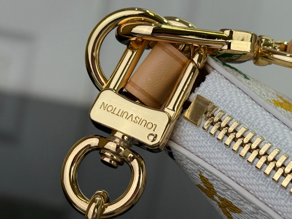 Louis Vuitton bag clasp and zipper pull with gold hardware and tan leather trim