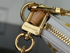 Louis Vuitton bag clasp and zipper pull with gold hardware and tan leather trim